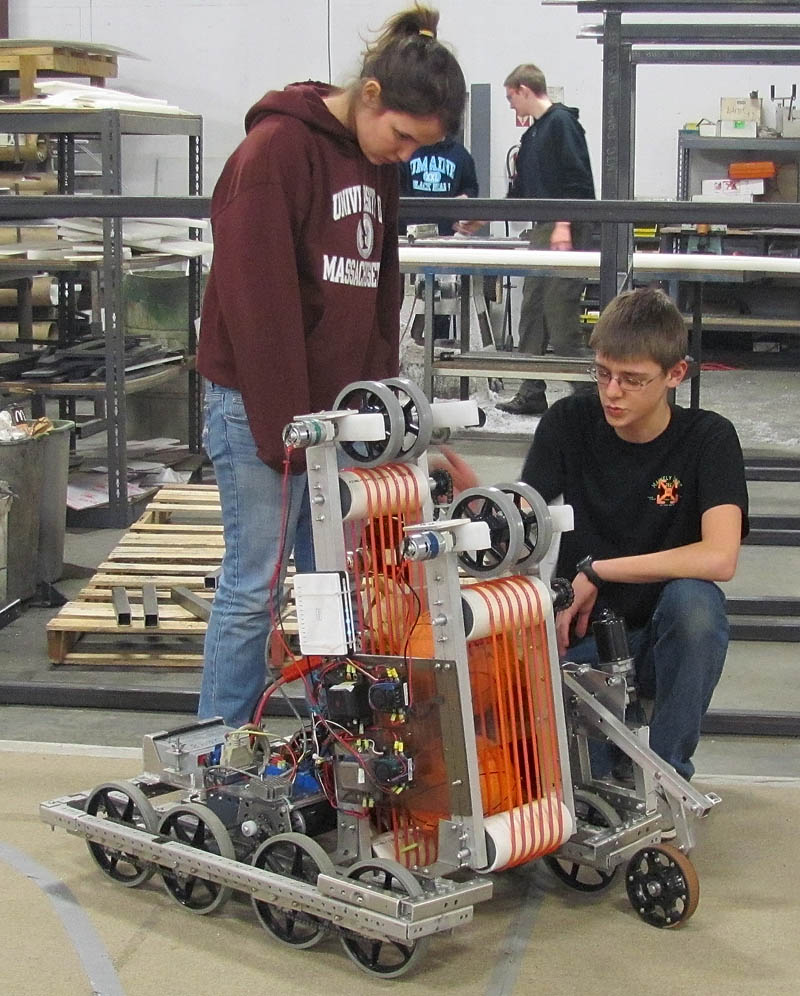 THE MACHINISTS: Infinite Loop Robotics Team members Sabine Fontaine and Brady Snowden handle the team's competition robot.