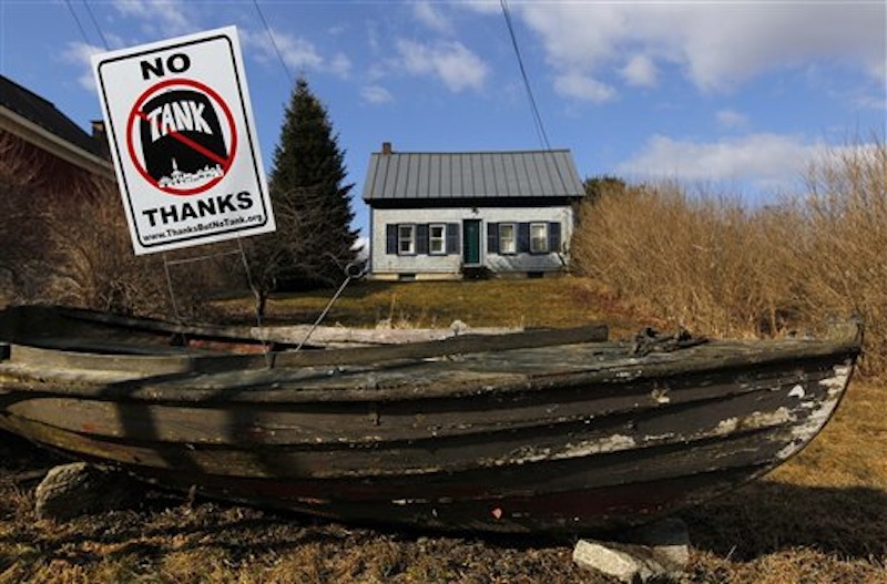 A sign opposing a proposed 23 million-gallon propane tank is seen in a dory in front of a home in Searsport.