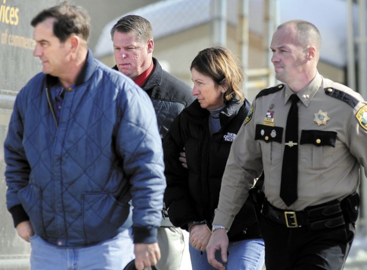 Chelsea Selectwoman Carole Swan, second from right, is led to Kennebec County jail in 2011 after being arrested at the Kennebec County Sheriff’s Office in Augusta. Swan was accompanied by, from left, her husband, Marshall Swan, after Detective David Bucknam and Sheriff Randall Liberty arrested her.