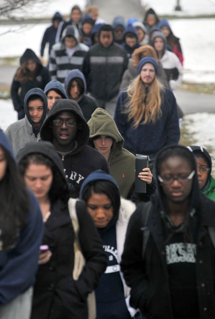 Colby College students wearing hooded sweatshirts and jackets as symbolic support of Trayvon Martin march across the Waterville school's campus Thursday. Martin was unarmed and wearing a hoodie when he was killed last month in Florida by a neighborhood watch member.