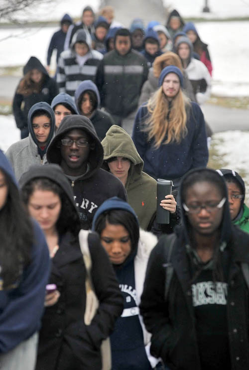 Colby College students wear hooded sweatshirts and jackets in symbolic support of Trayvon Martin as they march across the Colby campus in Waterville today.