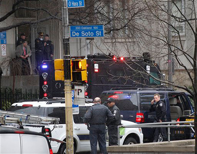 Police gather on DeSoto street near the front entrance to the Western Psychiatric Institute and Clinic on the University of Pittsburgh campus on Thursday, March 8, 2012 in Pittsburgh. (AP Photo/Keith Srakocic)