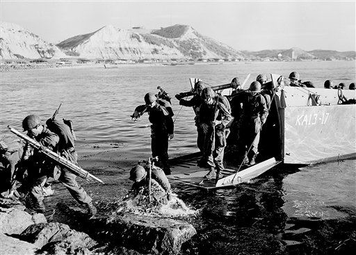 In this July 19, 1950, photo, troops of the First U.S. Cavalry Division land ashore at Pohang on the east coast of Korea during the Korean War.