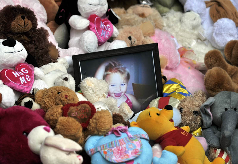 Photo by Michael G. Seamans A picture of Ayla Reynolds sits among a shrine of teddy bears on the steps of the Waterville City Hall during a vigil for missing toddler, Ayla Reynolds, at Castonguay Square in downtown Waterville Saturday.