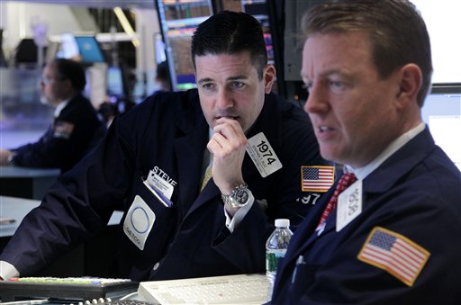 Traders work on the floor at the New York Stock Exchange in New York today as tocks in the were down more than 1 percent at the opening bell, following similar declines in Europe.