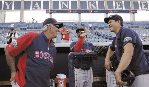 GLAD TO BE HERE: Boston Red Sox manager Bobby Valentine, left, chats with players Mike Aviles, center, and Jacoby Ellsbury before the team’s spring training game against the New York Yankees on Tuesday at Steinbrenner Field in Tampa, Fla.
