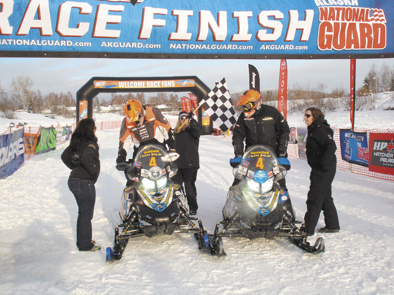 WE DID IT: Rob Gardner, left, and Dave Hammond cross the finish line at the Iron Dog snowmobile race. The duo finished ninth in the race, which is about 2,000 miles long.