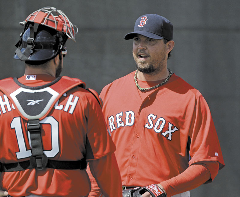 GETTING WORK DONE: Boston Red Sox pitcher Josh Beckett, right, talks with catcher Kelly Shoppach after a bullpen session Tuesday in Fort Myers, Fla. New Red Sox manager Bobby Valentine has made Sox pitchers work on improving defensively this spring.