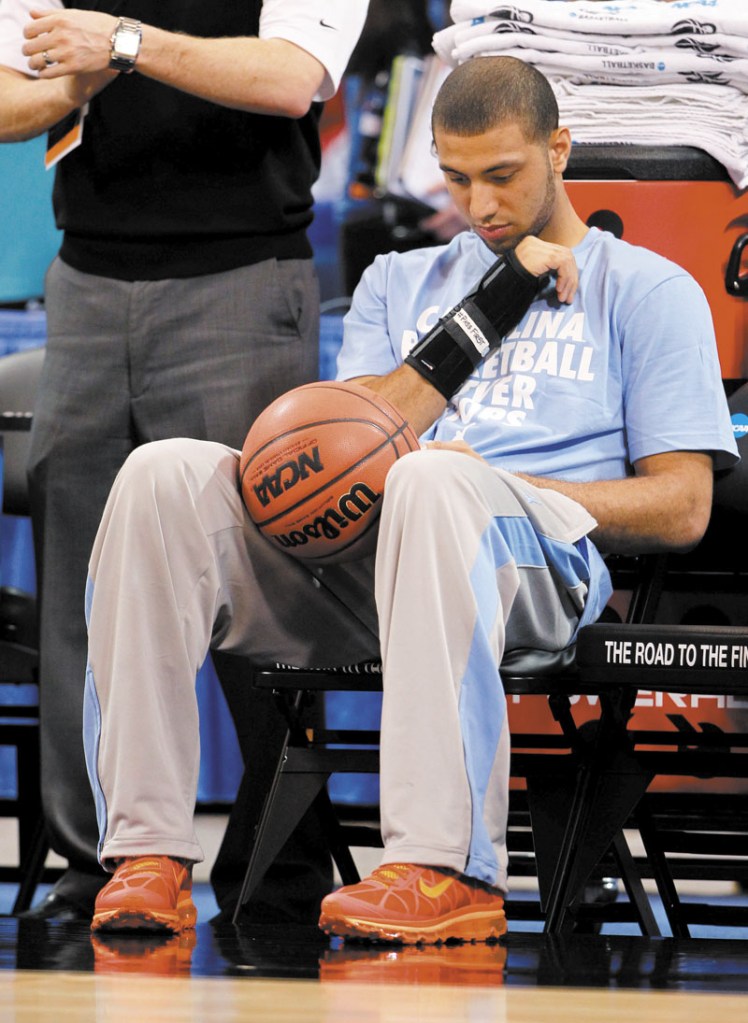 STATUS UKNOWN: North Carolina guard Kendall Marshall sits on the bench during practice Thursday in St. Louis. Marshall broke his right wrist and his status for today’s game against Ohio is uncertain.
