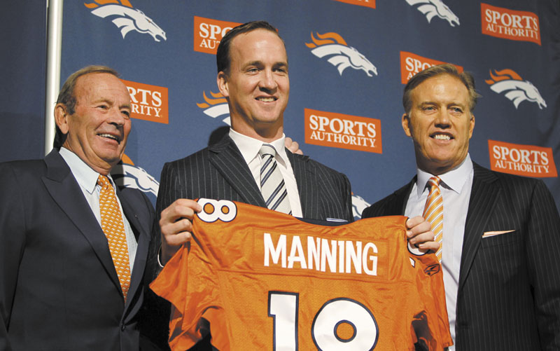 NEW HOME: Former Indianapolis Colts quarterback Peyton Manning, center, poses with Denver Broncos owner Pat Bowlen, left, and vice president of football operations John Elway at a press conferene Tuesday in Englewood, Calif. Manning signed a five-year contract with the Broncos for $96 million.