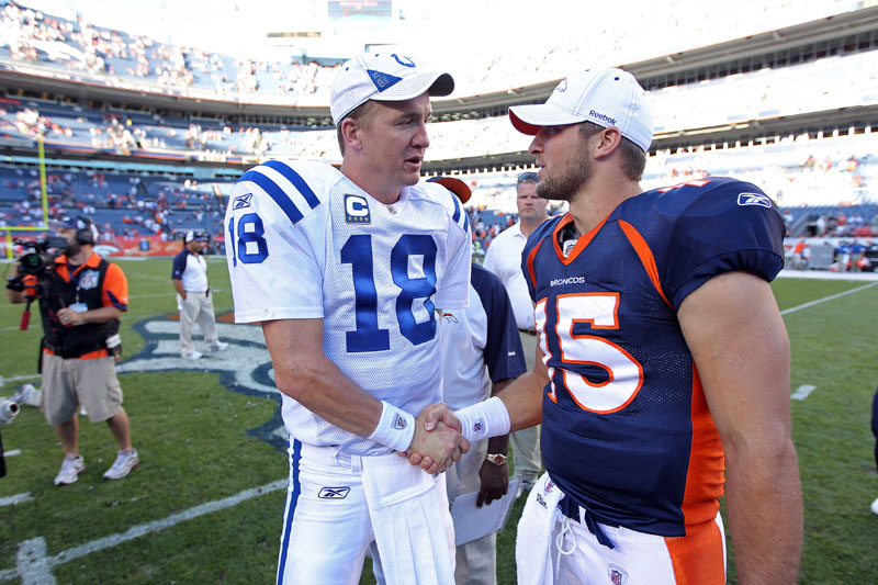 CROSSING PATHS: Former Indianapolis Colts quarterback Peyton Manning, left, greets Denver Broncos quarterback Tim Tebow before a 2010 game in Denver. Manning is negotiating to join the Broncos, ESPN reported on Monday. That decison would put Tebow’s future with the team in doubt. NFL