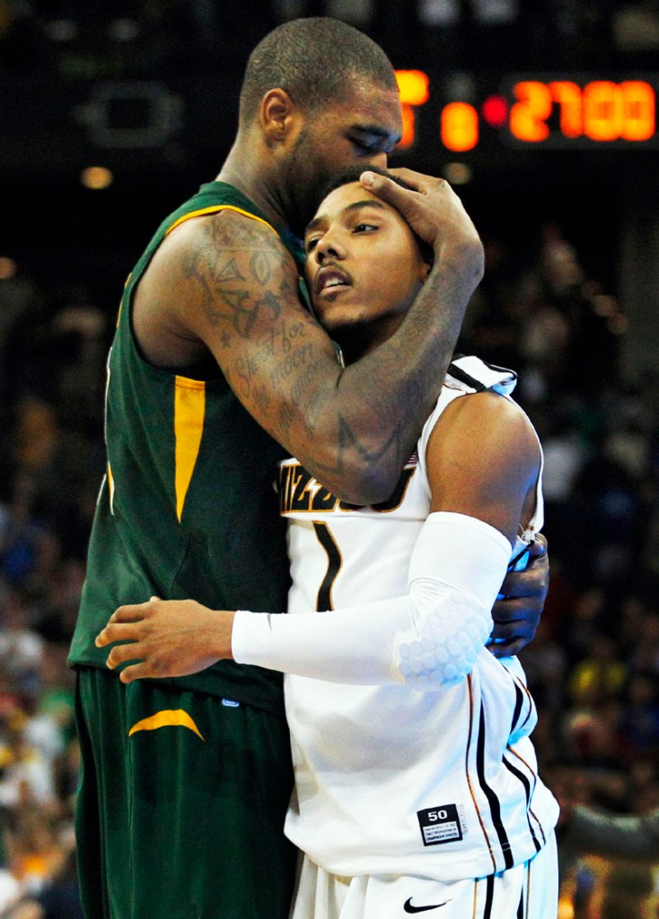 A SHOCKER: Norfolk State center Kyle O’Quinn, left, hugs Missouri guard Phil Pressey, right, after their second-round NCAA tournament game Friday in Omaha, Neb. Norfolk State won 86-84.