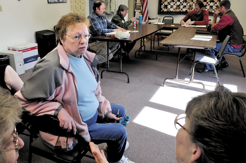 UNFINISHED BUSINESS: Charlotte Curtis, center, speaks with Norridgewock residents as the Norridgewock Board of Selectmen meet Monday at the town office. Selectmen decided to contact an attorney to determine how Curtis can serve the board of selectmen pending the resolution of prior duties as town treasurer.