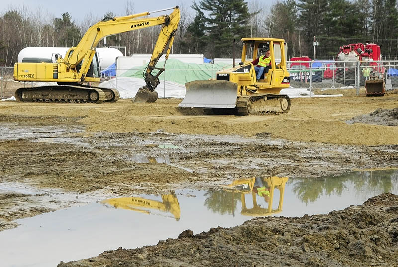 A worker operates a bulldozer at the oil spill cleanup site on Tuesday afternoon in Manchester.