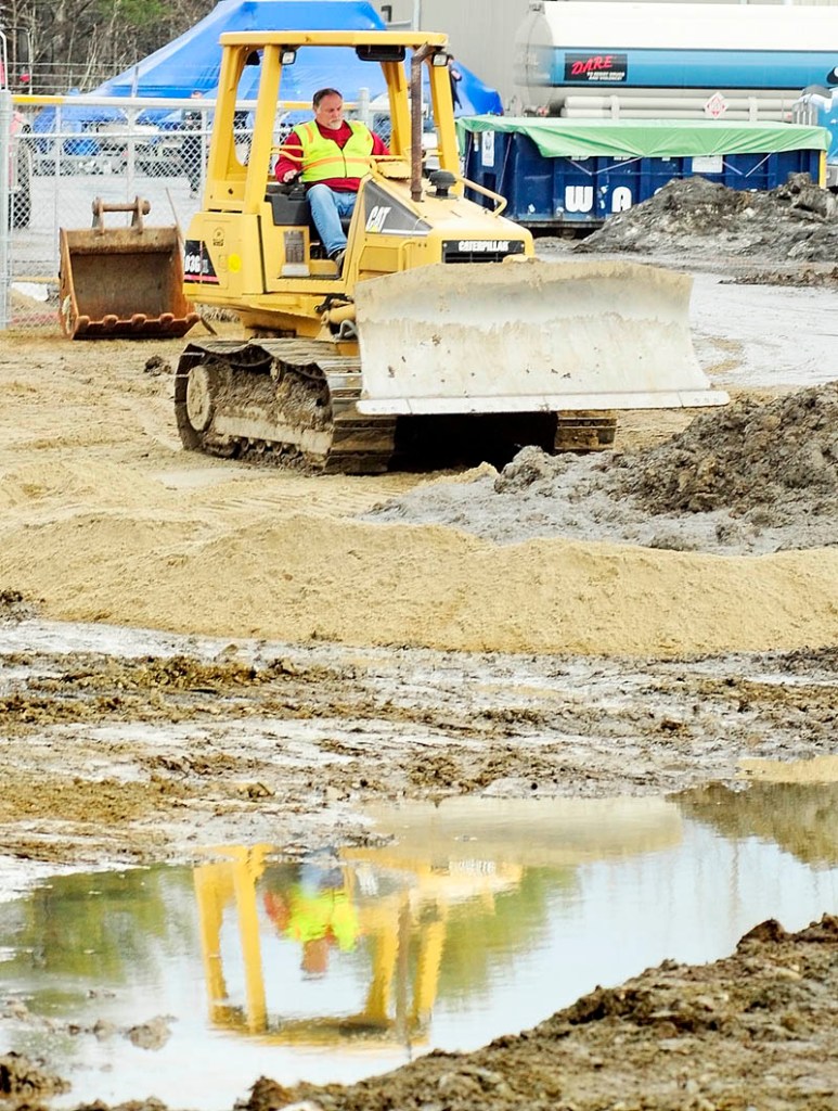 A worker operates a bulldozer at the oil spill cleanup site on Tuesday afternoon in Manchester.