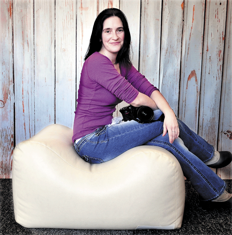 Portrait perch: Photographer Amanda Logiodice sits on one of the Bella Bun posers she invented and uses to steady infants while taking their portraits at her Amanda Rachel Photography studio in Pittsfield. Logiodice is raising money to help market the product.