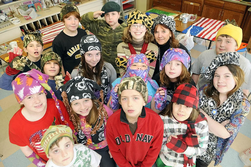 Fifth-graders pose for a photo wearing the hats they made in Betsy Allen-McPhedran's art class on Tuesday afternoon at Readfield Elementary School.