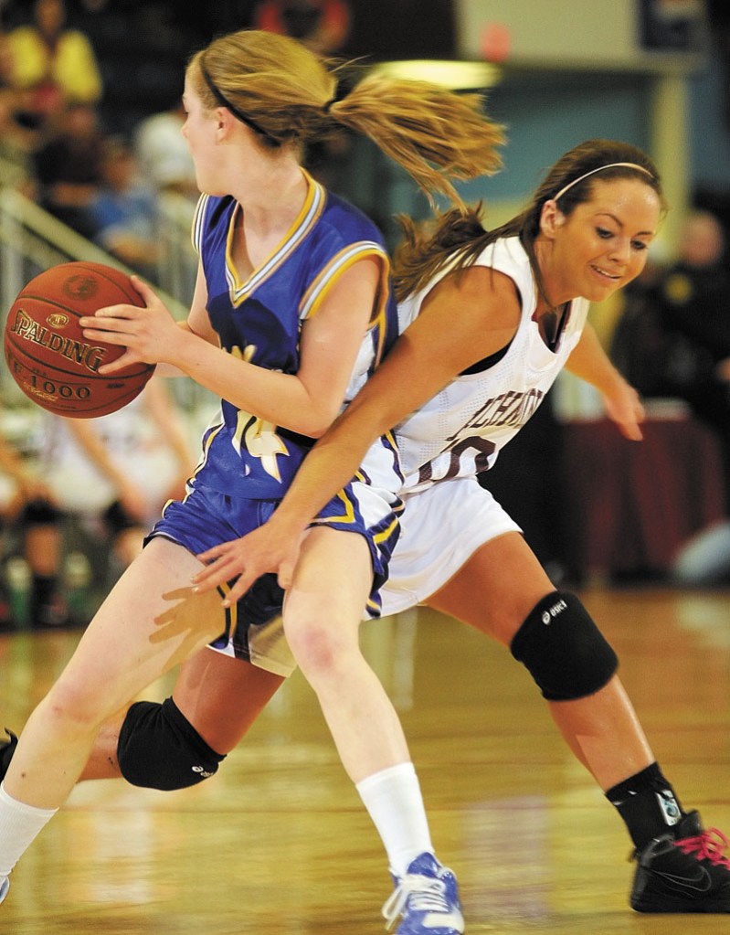 Washburn junior forward Mackenzie Worcester, left, steals the ball away from Richmond senior guard during the Class D state championship game on Saturday afternoon at the Augusta Civic Center.