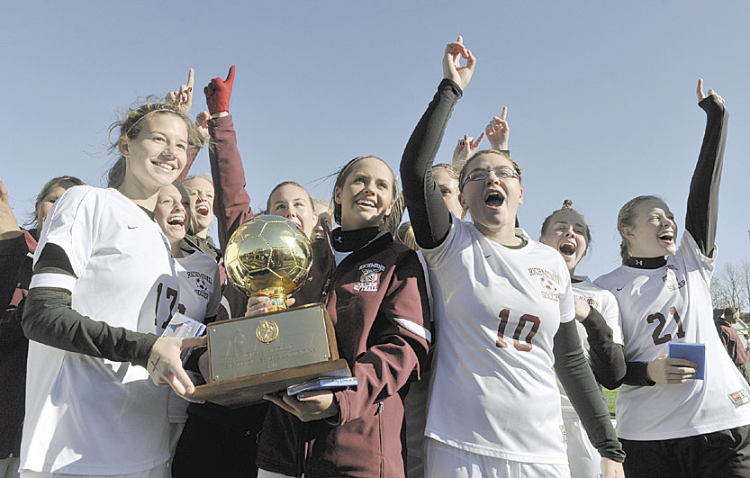 No. 1 again: The Richmond girls soccer team holds up the Gold Ball after winning the Class D state championship in the fall. This year’s junior class has won two state soccer titles.