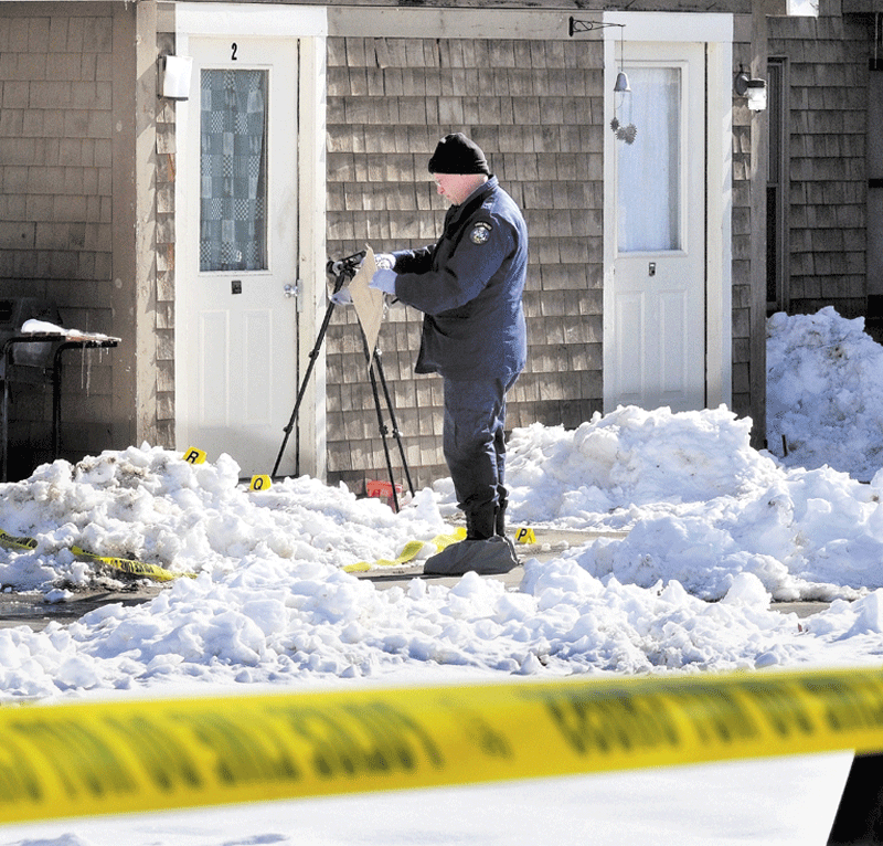 EVIDENCE: State police Detective Dean Jackson bags evidence near blood-spattered snow at the Indian Ridge apartments in Skowhegan on Wednesday whereJason Tibbetts was stabbed earlier in the day.
