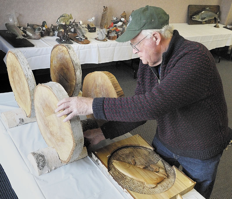 GETTING READY: John Hooper, of Rangeley, sets up carvings that are part of the art display and contests prior to the Maine Sportsman’s Show last year. This year’s show kicks off at 1 p.m. Friday at the Augusta Civic Center and runs through Sunday.