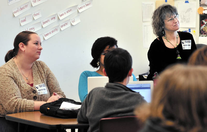 EDUCATING EDUCATORS: Regional School Unit 3 teachers Lindsey Bickford, left, and Kelly Desrosier watch as Messalonskee Middle School teacher Linda Haskell teaches using a standard-based teaching program recently.