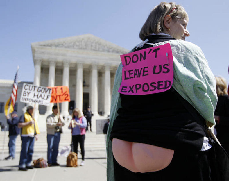 Joan Stallard, who supports health care reform, stands in front of the Supreme Court after Tuesday’s session.