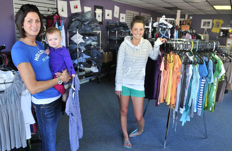 Erin Savage, holding her daughter Grace, and co-owner Hope Allain of The Swap boutique in Skowhegan are sponsoring a fashion show on Sunday to benefit the women’s homeless shelter in Solon. The show is from 3 to 6 p.m. at T&B Celebration Center.