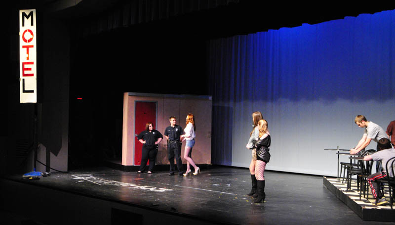 Winthrop High School students rehearse "The Queen of TE" on Tuesday at the school. Their entry in the State Drama Festival features a large lighted sign and two sets that swing on and off stage.