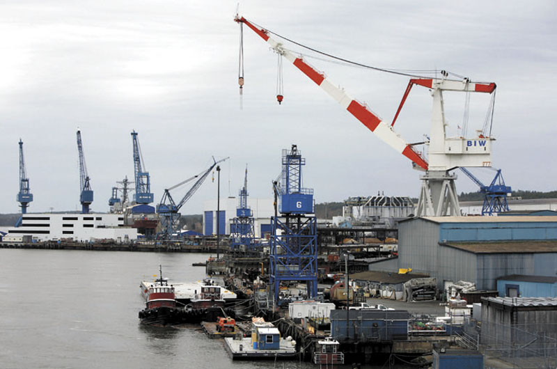 In this 2009 file photo, a large crane towers over the Bath Iron Works shipyard. Bath Iron Works had a storage building damaged in a fire on Tuesday, April 4, 2012. (AP File Photo)