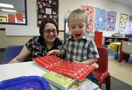 In this April 4, 2012, photo, Kelly Andrus plays with her son Bradley, in his classroom at Children's Choice Learning Centers Inc., in Lewisville, Texas. Bradley, who turns three in a couple of weeks, was diagnosed a year ago with mild autism. For the first time in nearly two decades, experts want to rewrite the definition of autism. Some parents fear that if it's narrowed and their kids lose the label, they may also lose out on special therapist. (AP Photo/Tony Gutierrez)