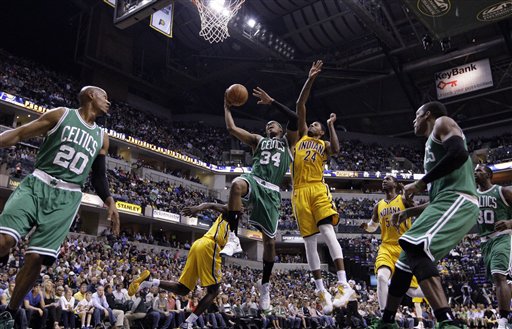 Indiana Pacers guard Paul George, blocks the shot from behind Boston Celtics forward Paul Pierce in the first half of an NBA basketball game in Indianapolis, Saturday, April 7, 2012. (AP Photo/Michael Conroy)