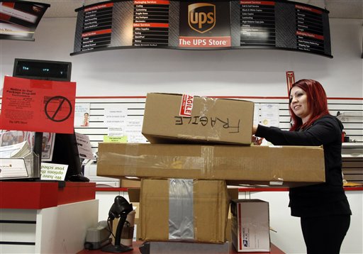Employee Candy Mojica weighs packages before shipping at The UPS Store in Los Angeles recently.