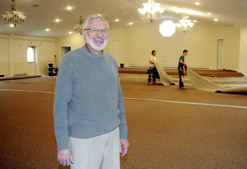 Workers install carpets Thursday in the newly renovated chapel at the Faith Christian Church in Gardiner where Pastor Glenn Metzler officiates.