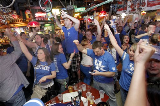 University of Kentucky fans celebrate after the final horn on Monday at Lynagh's Irish Pub & Grill in Lexington, Ky.