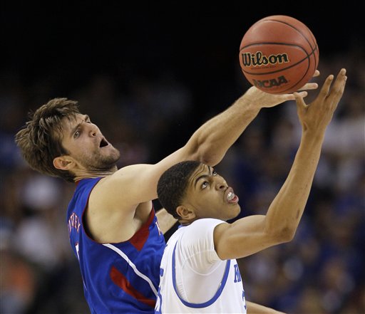 Kansas' Jeff Withey fights for a loose ball with Kentucky's Anthony Davis, right, during the first half of the NCAA Final Four tournament college basketball championship game tonight in New Orleans.