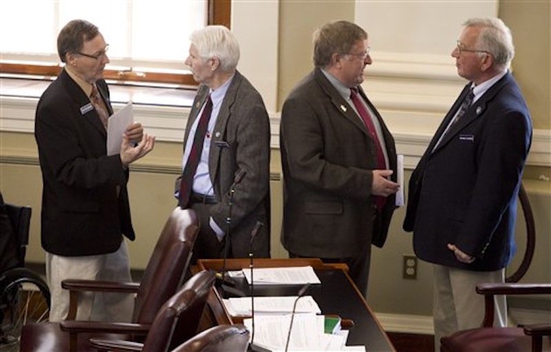In this April 13, 2012 photo, State Reps., from left: Peter Edgecomb, R-Caribou, Bernard Ayotte, R-Caswell, James Parker, R-Veazie, and Wesley Richardson, R-Warren, confer before the start of a House session, at the State House in Augusta, Maine. Gov. Paul LePage and Maine's Republican-majority Legislature have left their mark on the 2012 election-year session. (AP Photo/Robert F. Bukaty)
