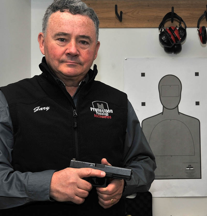 SELF-DEFENSE: Gary Hilliard, owner of a firearms training school in Belgrade, poses for a portrait in his classroom.