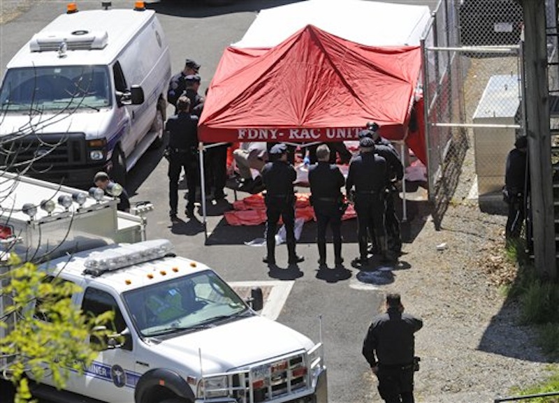 Police surround a temporarily built tent where the victims of the vehicle crash were brought, Sunday April 29, 2012, in New York. Authorities say the out-of-control van plunged off a roadway near the Bronx Zoo, killing seven people, including three children. (AP Photo/ Louis Lanzano)