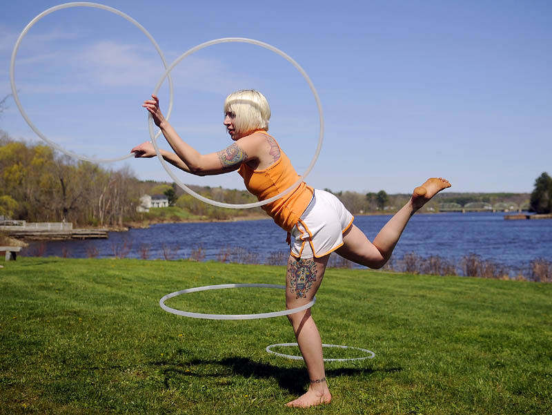 Alexis Golubow, of Richmond, rehearses her hula hoop performance Thursday at the park on the Kennebec River in Richmond. Golubow, who performs professionally, said frequent practice is warranted to twirl as many as four ovals at once.
