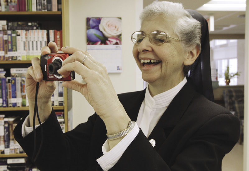 SAY CHEESE: Sister Elaine Lachance takes a photo at the St. Joseph Convent in Biddeford earlier this month. Good Shepherd Sisters of Quebec has just six convents in Maine and Massachusetts with fewer than 60 sisters.