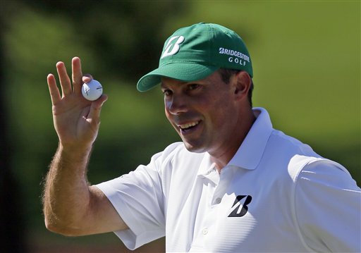 Matt Kuchar holds up his ball after a birdie putt on the seventh green during the third round of the Masters golf tournament today in Augusta, Ga.