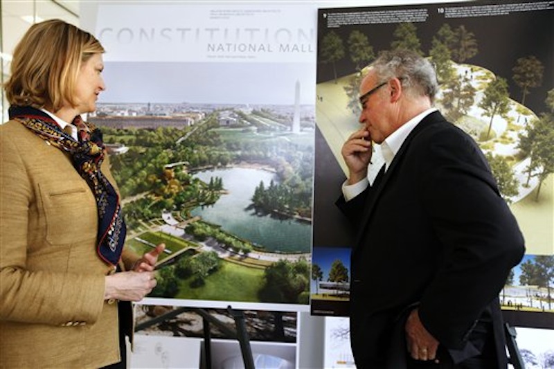 In this photo taken Thursday, April 5, 2012, Caroline Cunningham, President of the Trust for the National Mall, left, and Donald Stastny, an architect advising the trust, look at two of several proposed designs for overused and neglected areas of the National Mall in Washington. (AP Photo/Jacquelyn Martin)