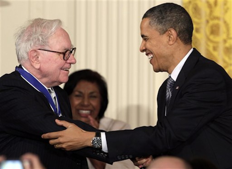 In this Feb. 15, 2010, file photo President Barack Obama congratulates Warren Buffett after presenting him with a 2010 Presidential Medal of Freedom in an East Room ceremony at the White House in Washington. In his weekly radio and internet address Saturday April 14, 2012, Obama urged Americans to ask their member of Congress to support the "Buffett Rule," named after the billionaire investor who says he pays a lower tax rate than his secretary. Obama says the nation can't afford to keep giving tax cuts to the wealthiest, "who don't need them and didn't even ask for them." (AP Photo/Carolyn Kaster)