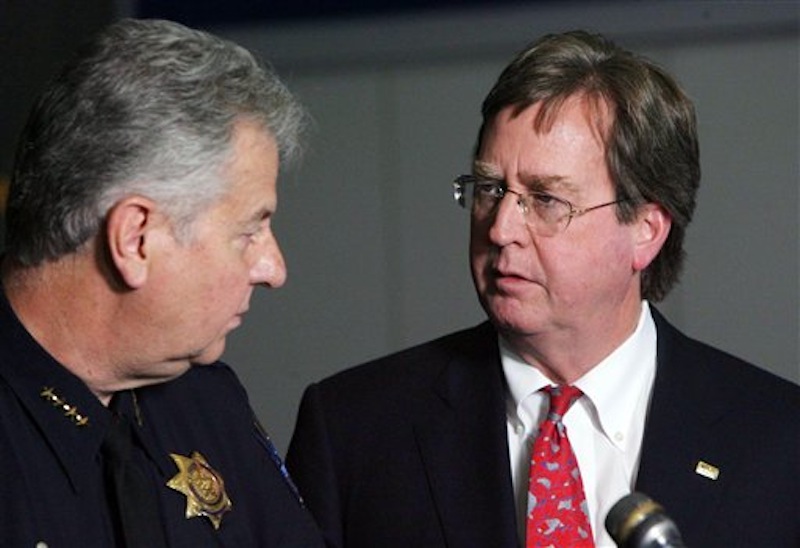 Tulsa Mayor Dewey Bartlett, right, chats with Tulsa Chief of Police Chuck Jordan during a news conference at the Tulsa Police Department on Saturday, April 7, 2012 in downtown Tulsa, Okla. Police believe the same attacker or attackers are behind a series of early-morning shootings in which three people were killed and two others were critically wounded within a three-mile span of north Tulsa. (AP Photo/Tulsa World, James Gibbard)