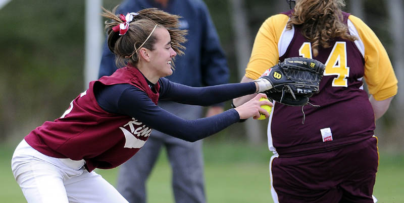 Staff photo by Andy Molloy BALL IN THE HAND: Richmond High School's Jamie Plummer can't connect with an out at first after a late throw to allow Buckfield High School's Hannah Gallant to take the base during a softball match up at Richmond.