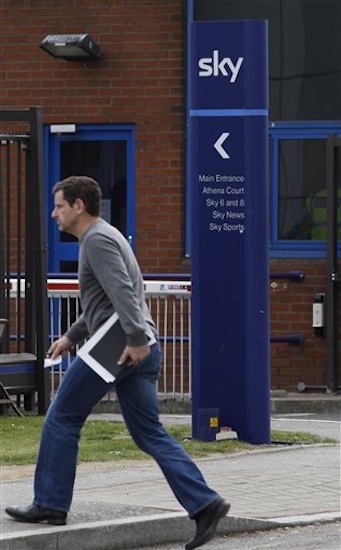 A man walks to the entrance of one of the BSkyB headquarter buildings complex, in west London on Tuesday, April 3, 2012. (AP Photo/Lefteris Pitarakis)