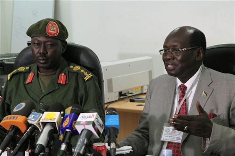 South Sudanese Minister of Information Barnaba Benjamin Marial, right, and Military Spokesman Philip Aguer brief the media on Tuesday, March 27, 2012 in Juba, South Sudan about recent fighting between Sudanese and South Sudanese forces along the north-south border. South Sudan said Wednesday, April 4 it had shot down a Sudanese jet after its oil fields were bombed. (AP Photo/Michael Onyiego)
