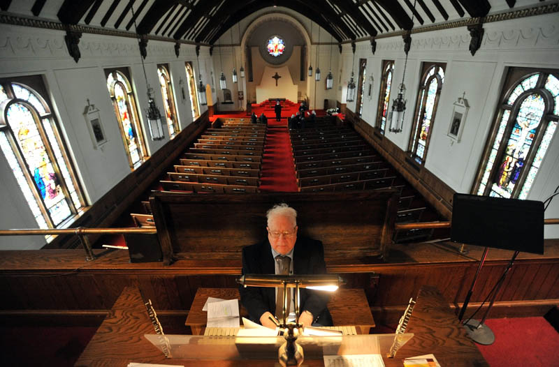 Staff Photo by Michael G. Seamans Dr. Stanley Painter plays the organ during the Holy Trinity Anglican Church's Stations of the Cross service at Sacred Heart Church in Waterville. The Holy Trinity Anglican Church rents space at Sacred Heart Church.