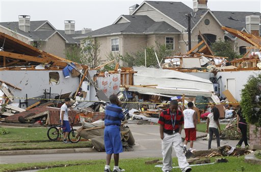Neighbors view what remains of a home in Arlington, Texas, Tuesday.